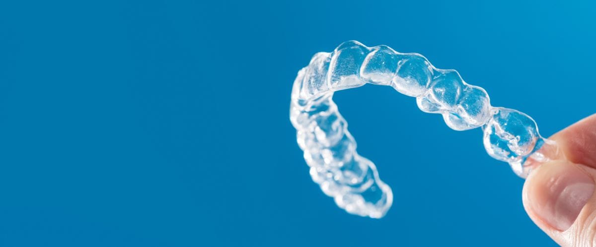 prozoren ortodontski aparat v roki